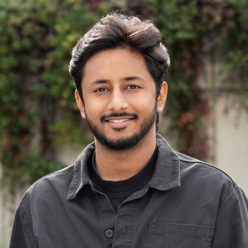 Sampreet Sidhu smiling outdoors.