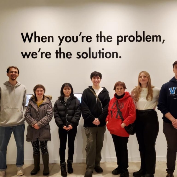 ANTH 335 VAG Field Trip, 20 January 2024.  Students in front of exhibit, "When you're the problem..."