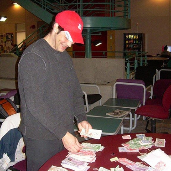 How much? Steve, one of the ANTH 316 students, counts Canadian Tire money; it is being donated to the Haven House Women's Shelter. 