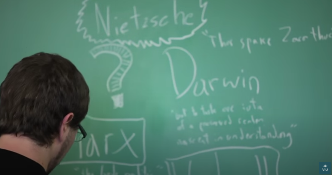 Man at a blackboard with writing