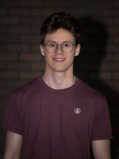 A young man with glasses and short hair.