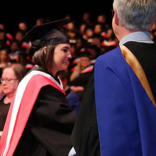Sharae receiving degree from John Black, Dean of Social Sciences