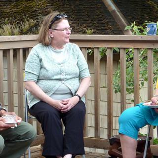 In conversation Andrew's father, Clark's mother, and Lynette relaxing and talking