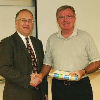 Dr. Ralph Nilsen, President of Vancouver Island University presents a gift of appreciation to Dr. Don Stone, outgoing Chairman of the Geography Department, who retired in 2008
