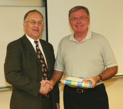 Dr. Ralph Nilsen, President of Vancouver Island University presents a gift of appreciation to Dr. Don Stone, outgoing Chairman of the Geography Department, who retired in 2008